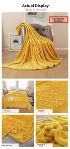 Close-up of ginger yellow flannel blanket featuring 3D diamond jacquard and stitched edges