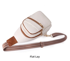 Detail of white lychee leather chest bag with ethnic woven strap and gold metal hardware
