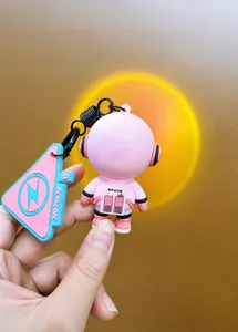Close-up of pink astronaut keychain featuring built-in sunset atmosphere lamp