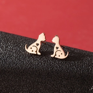 Macro shot of rose gold cat stud earrings with hollow heart and star patterns