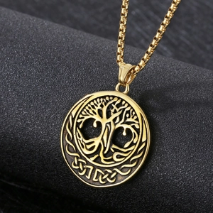 Macro shot of gold Celtic Tree of Life pendant with intricate embossed knot details