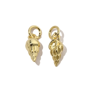 Detailed macro view of golden conch shell charms for DIY jewelry and necklaces