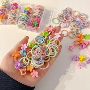 Close-up of colorful kids' elastic hair ties and mini floral hair claw clips set