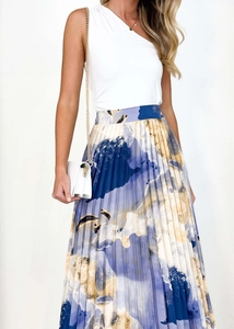 Close-up of elegant pleated skirt with abstract oil painting print and draped texture