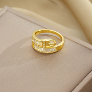 Close-up of gold belt buckle ring featuring rectangular and round zircon stones