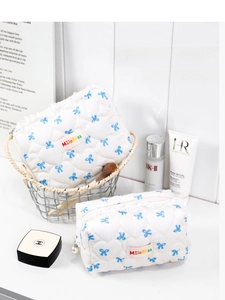 Quilted cotton makeup bag set with blue bow patterns and elegant pearl zipper detail