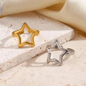 Minimalist stainless steel star rings in gold and silver finish on stone tray