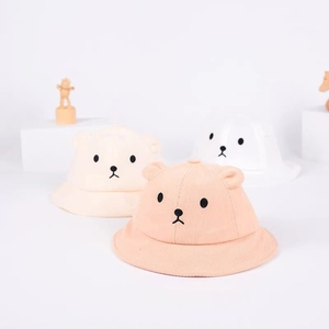 Detail of baby sun hats featuring cute 3D bear ears and soft corduroy fabric in pastel colors
