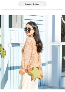 Outdoor shot of a yellow star-shaped PVC jelly bag with gold chain strap on a model