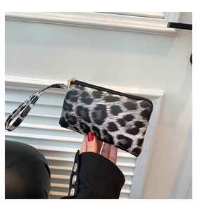 Close-up of leopard print handbag with black zipper and high-quality leather texture