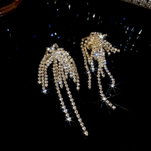 Macro shot of sparkling tassel earrings with shimmering rhinestone chains in silver