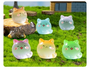 Micro landscape featuring six luminous miniature cats in gradient colors on moss