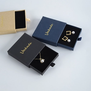 Detail of drawer-style jewelry boxes in black, blue and kraft paper with velvet lining