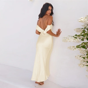 Detail of champagne satin backless dress showing off-shoulder design and elegant fabric texture
