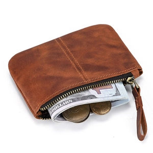 Detail of vintage brown leather coin pouch showing zipper and cash storage