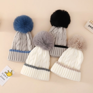 Winter baby cable knit hats with large pom-poms in blue, black, grey and beige colors