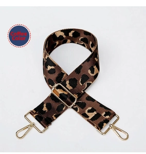 Close-up of leopard print coffee brown bag strap with adjustable gold metal hardware