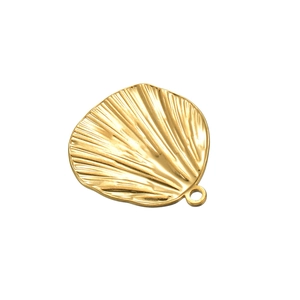 Detailed view of a golden scallop shell pendant with fine radial textures and hanging hole