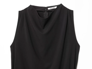 Detail view of the sleek back zipper closure on a black sleeveless turtleneck top