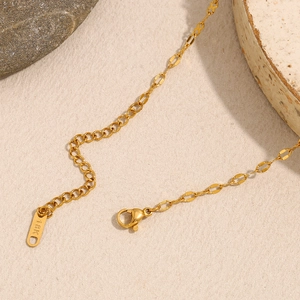 Close-up of 18K gold plated cross necklace showing the clasp and engraved hallmark