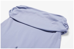 Close-up of wide high-waisted fold-over waistband on light purple yoga flare pants