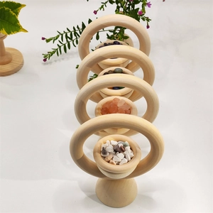 Row of wooden essential oil diffusers with colorful crystals on a white background