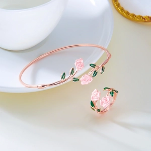 Detailed macro of rose gold enamel flower bracelet and matching open ring set