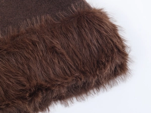 Detailed close-up of premium dark brown faux fur trim and wool fabric on a warm winter set