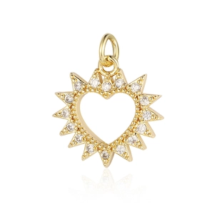 Macro shot of gold-plated heart pendant with sunburst edges and clear zircon inlay