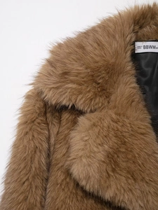 Detailed macro of brown faux fur coat collar with soft texture and inner lining