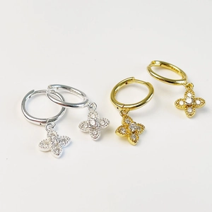 Macro view of S925 sterling silver clover hoop earrings with cubic zirconia stones