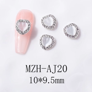 Detail of heart cat-eye nail charms with silver rhinestone borders measuring 10x9.5mm