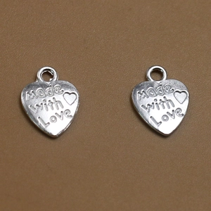 Primer plano de colgante de aleación en forma de corazón con grabado Made with Love