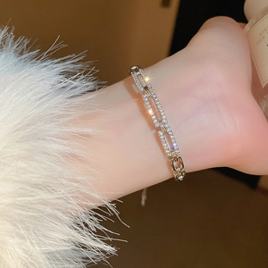 Detailed view of silver-tone hollow rectangular link bracelet with cubic zirconia