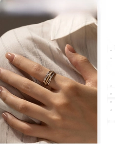 Detail of s925 silver and gold mixed layered ring with sparkling diamonds on hand