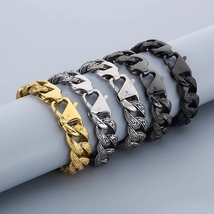 Detail of vintage engraved Cuban chain bracelets in five metallic finishes on a cylinder