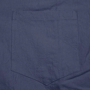 Detail of chest pocket on dark blue linen shirt with double-stitch sewing process
