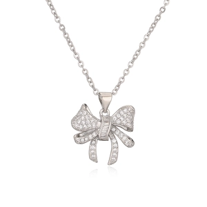 Silver bow pendant necklace with micro-paved zircons on a white background