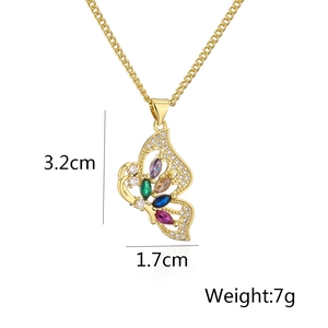 Macro view of gold-plated butterfly pendant with multicolored gems and dimensions 3.2cm x 1.7cm