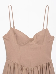Close-up of heart-shaped neckline and spaghetti straps on a beige linen midi dress