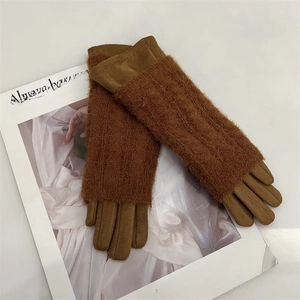 Detail of warm brown suede and knit plush gloves shown on a fashion magazine background