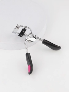 Macro view of silver eyelash curler with integrated black comb teeth and pink accents
