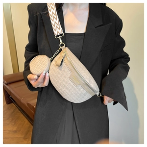 Detail of beige woven crescent bag with jacquard strap and small round coin purse pouch