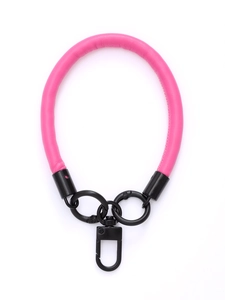 Close-up of pink leather phone wrist strap with black metal spring rings and swivel hook