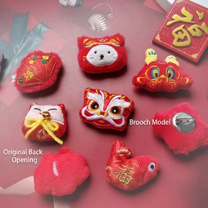 Chinese New Year plush brooches featuring dancing lion, koi fish and lucky cat motifs