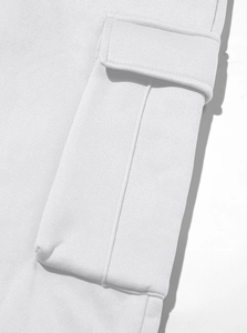 Detailed macro view of white cargo pocket stitching and high-quality cotton fabric texture