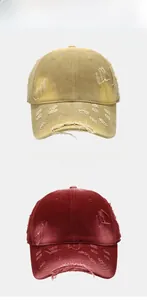 Detail of vintage washed baseball cap showing distressed torn fabric in yellow and red
