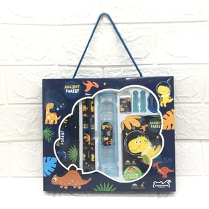 Detail of blue dinosaur-themed stationery set including pencils, ruler and notebook
