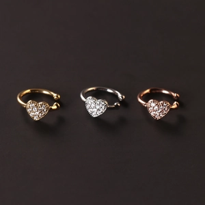 Three minimalist C-shaped heart ear cuffs with white zircon inlay in gold, silver, and rose gold
