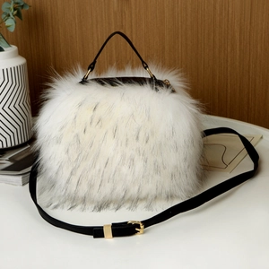 Close-up of white faux fur handbag with black straps and golden hardware details